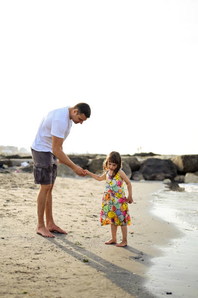 istock Real family on a sandy beach. 1850399255