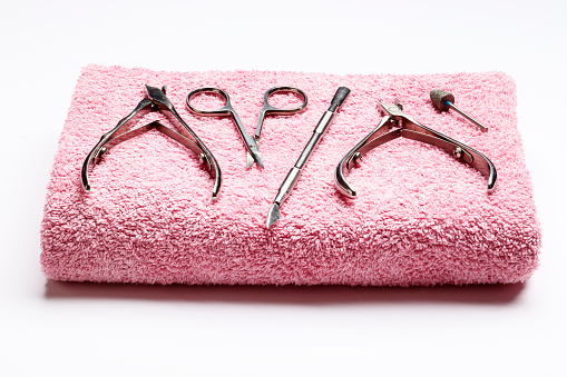 A set of tools for manicure on a pink towel. Insulation.