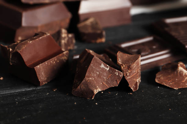 istock Dark chocolate pieces and bar close-up. Top view. Place for text. 1850407266