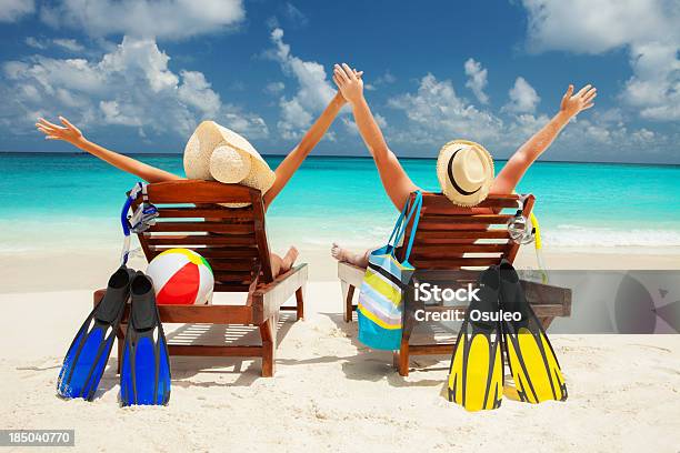Couple Sitting On Beach With Arms Raised Stock Photo - Download Image Now - Beach, Couple - Relationship, Hawaii Islands