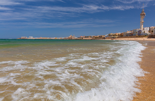 View of the sandy beach and the Atlantic Ocean on a sunny day. Cadiz. Spain. Andalusia.