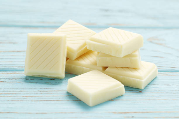 istock White chocolate pieces on wooden table 1850410640