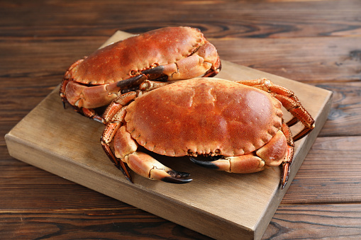 Two delicious boiled crabs on wooden table