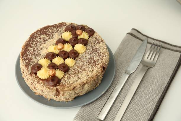 istock Delicious Kyiv Cake decorated with cream and hazelnuts on white table 1850423129