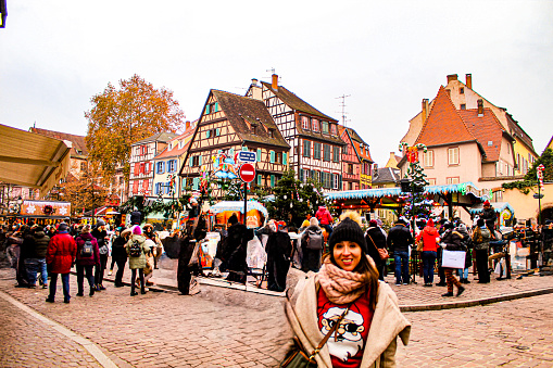 Image of a beautiful woman enjoying a Christmas market in the village of Colmar
