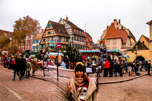 Image of a woman in a Christmas market in the village of Colmar