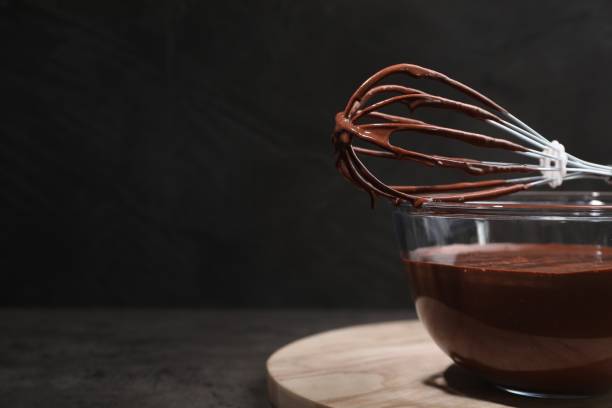 istock Bowl of chocolate cream and whisk on gray table, space for text 1850435222