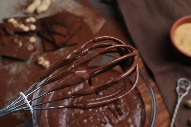 istock Whisk with chocolate cream above bowl, closeup 1850435743