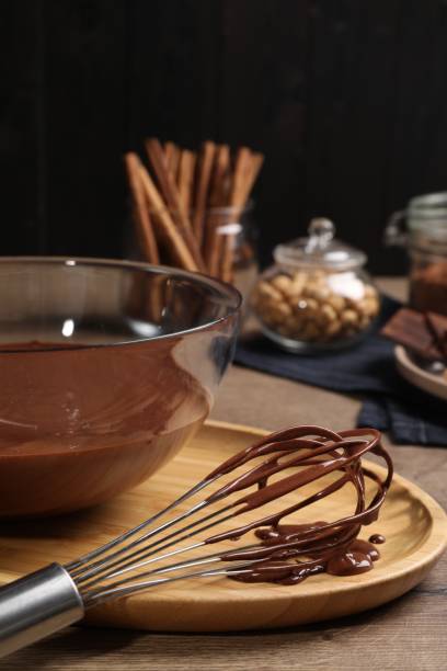 istock Bowl and whisk with chocolate cream on wooden table 1850436777