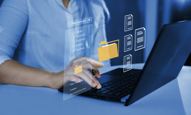 istock document management system concept. Businesswoman working on laptop with virtual screen. Process automation to efficiently manage files. 1850448824
