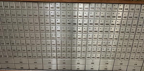 Safety deposit boxes of an old bank with some left open. Selective focus is used.