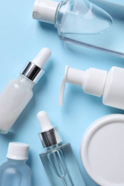 istock Many different bottles of cosmetic serum on light blue background, flat lay 1850480576