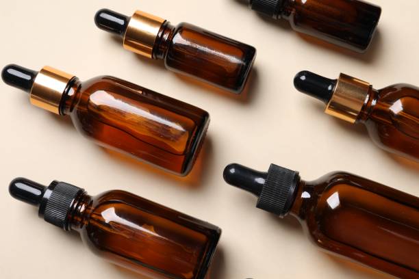 istock Many bottles with face serums on beige background, above view 1850481928