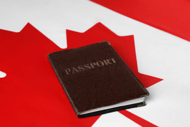 istock Immigration to Canada. Passport on flag, closeup 1850492661