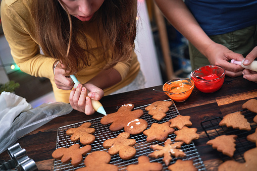 Teenage Girls Trying to Prepare Christmas Cookies in Domestic Kitchen