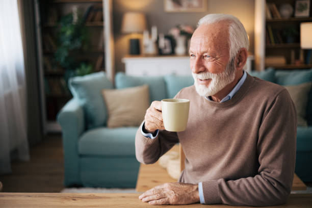 istock Elderly bearded man drinking coffe in the dining room 1850534316