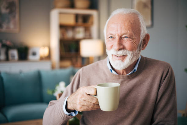 istock Elderly bearded man drinking coffe in the dining room 1850534326