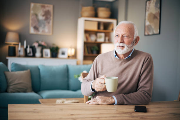 istock Elderly bearded man drinking coffe in the dining room 1850534949