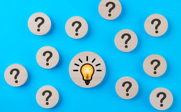 istock Problem solving concept. Question mark and light bulb icons on round wooden on blue background. Creative thinking, innovation, and idea, Business solution company, Find solution, Step idea process, 1850540581