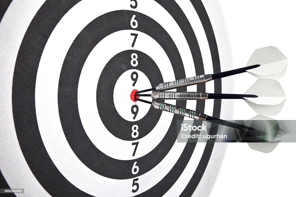 Target Dartboard with three darts on the bulls eye. Accuracy Stock Photo