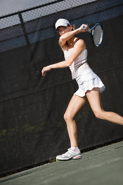 istock young woman playing tennis 185054412