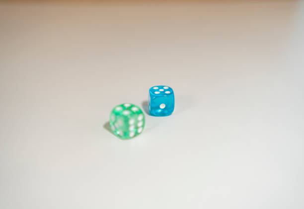 Blue and green dice only one in focus, see through dice