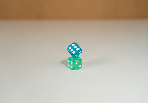 Green and blue dice on top of each other, see through