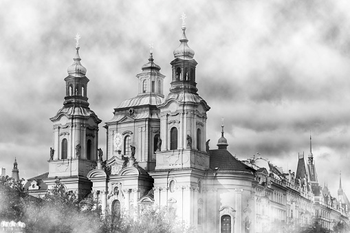 St. Nicholas Church (Staré Město) in old town, Prague, Czech Republic. Late-Gothic and Baroque church was built between 1732-1737. Black and white photo.