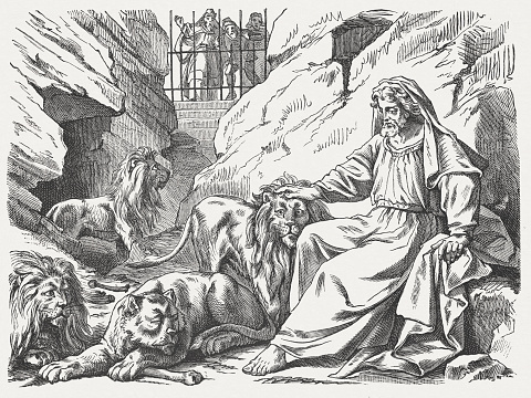 Daniel in the lions den. Woodcut engraving after a drawing by Julius Schnorr von Carolsfeld (German painter, 1794 - 1872), published in 1877.
