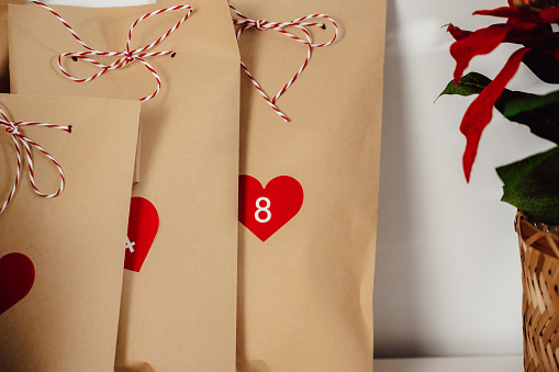 Christmas concept. closeup Craft advent calendar bags with little gifts.