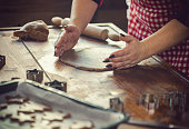 Woman making traditional gingerbread cookies for Christmas holidays