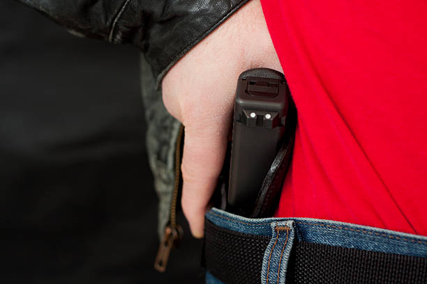 istock Concealed Carry Firearm Drawn From an Inside-the-Waistband Holster 185056347