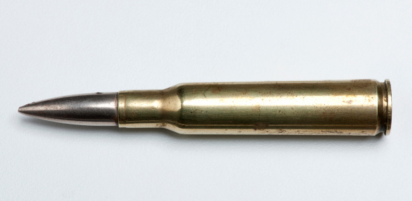 Old rifle cartridge isolated on white background.