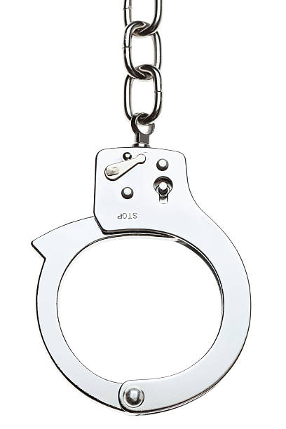 Close-up of stainless handcuff with a chain Detail shot of handcuffs, isolated on white. Perfect isolation achieved in camera. (5D Mark II, Adobe RGB) chain object photos stock pictures, royalty-free photos & images