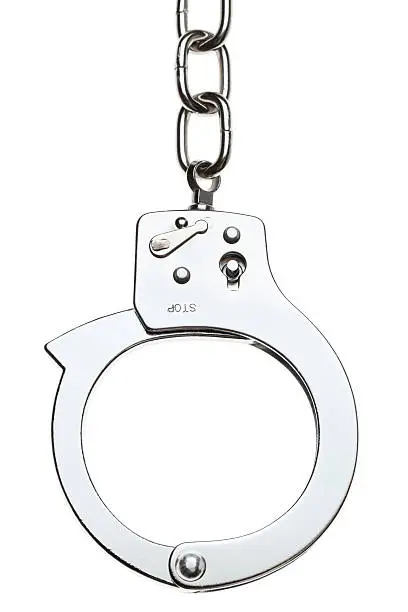 Photo of Close-up of stainless handcuff with a chain