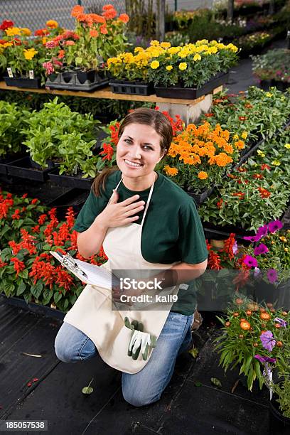 Worker Taking Inventory In Retail Garden Center Stock Photo - Download Image Now - Gardening, Kneeling, 20-29 Years