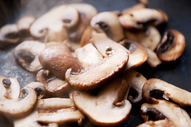 istock sliced field mushrooms cooked in open pan 185057701