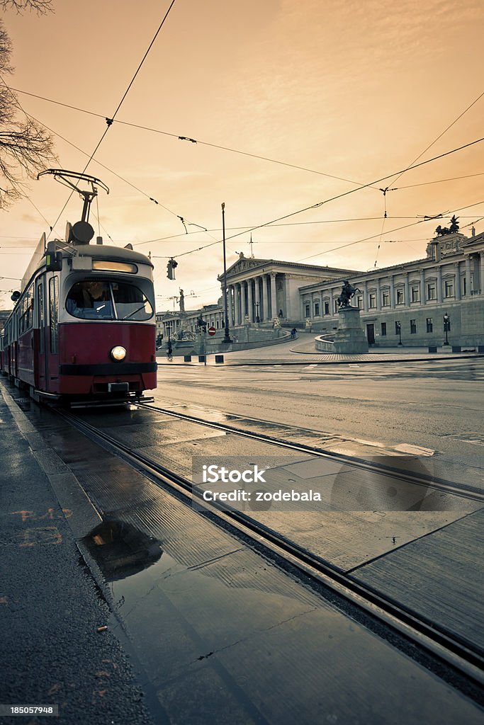 Austrian Parliament in Vienna, Car and Tram Traffic at Sunset The government building of the austrian parliament in Vienna Parliament Building Stock Photo
