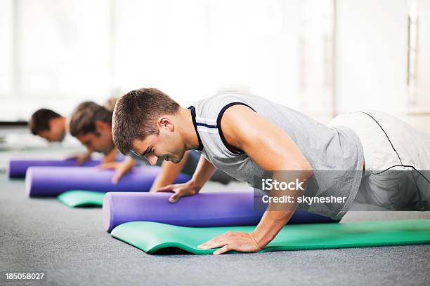 Group Of Young People Doing Pilates Exercises Stock Photo - Download Image Now - Gym, Health Club, Pilates