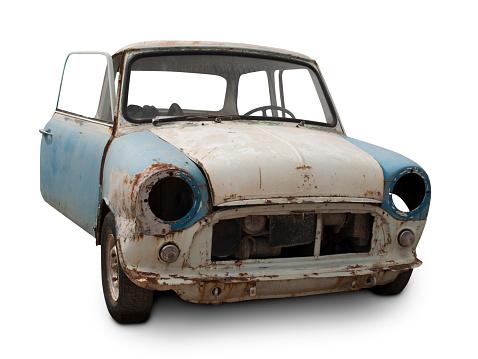 Mini morris abandoned without headlights, rusted and broken body.