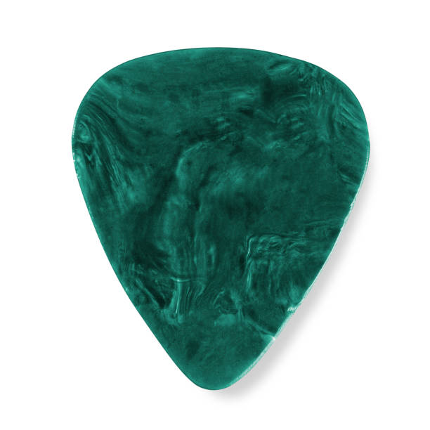 Green Plectrum "Photo of a patterned, green, plastic guitar pick/plectrum showing signs of use" plectrum stock pictures, royalty-free photos & images