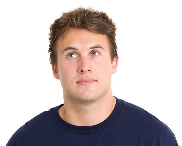 Young Man Looks Up in Thought Portrait of a young man on a white background. http://s3.amazonaws.com/drbimages/m/ec.jpg Distracted stock pictures, royalty-free photos & images