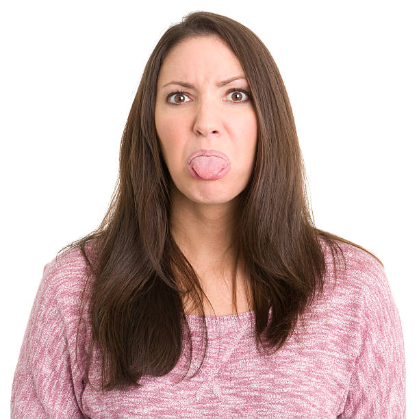 istock Young Woman Sticks Out Tongue 185059264