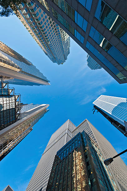 istock Downtown skyscrapers soaring into blue sky 185059492