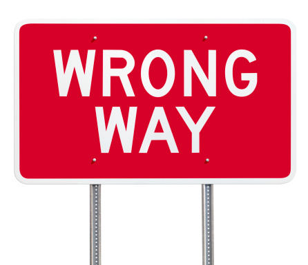 Conceptual road sign indicating the wrong way - a clipping path is included to separate sign from bkg.