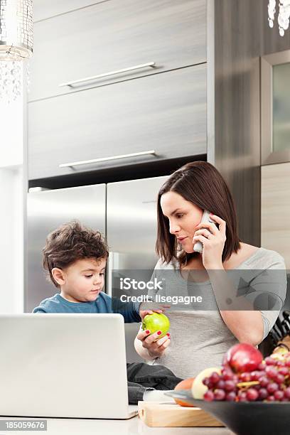 Pregnant Woman With Son In Kitchen Stock Photo - Download Image Now - 2-3 Years, 30-39 Years, 4-5 Years