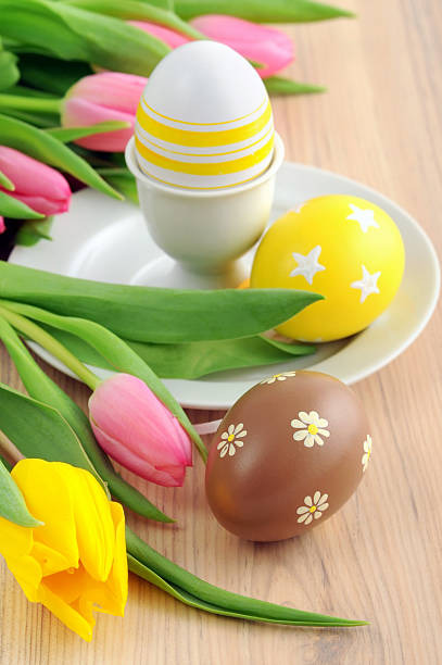 istock bunch of tulip laying aside an easter Egg at Eggcup 185060233