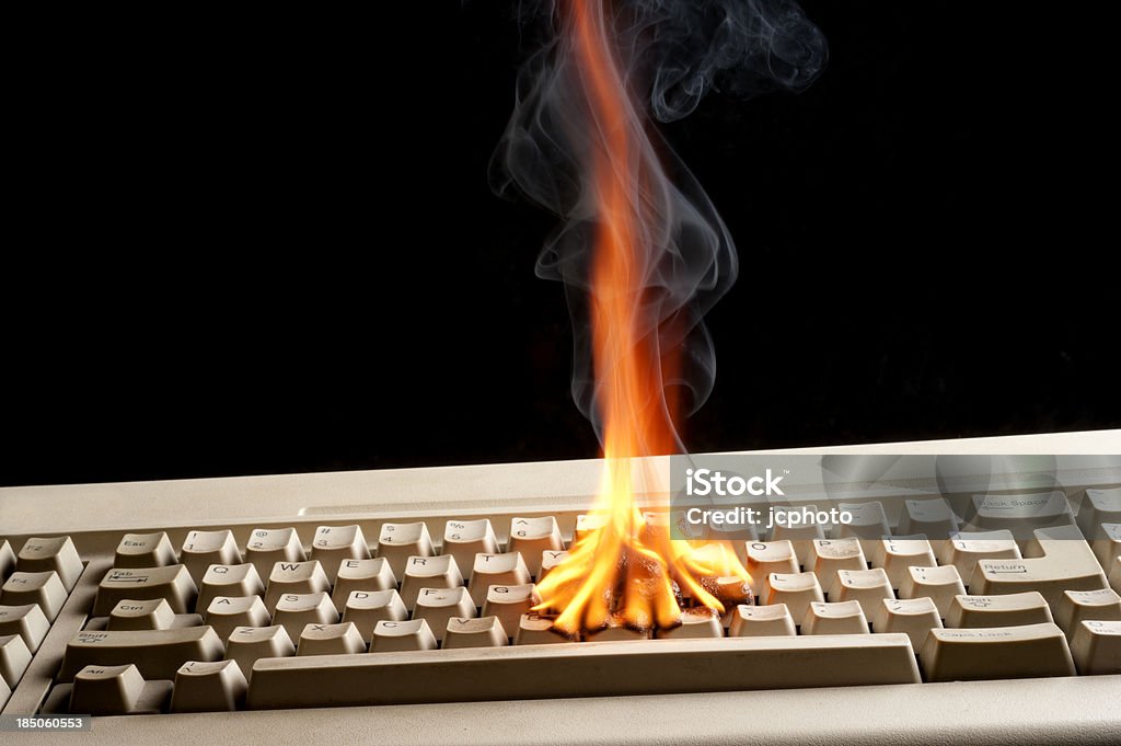 Key board on fire computer keyboard on fire with black background Accidents and Disasters Stock Photo