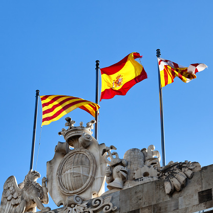 Flags of Spain (middle), Catalonia (left) and Barcelona (right).