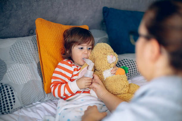 istock Little boy having inhalation at home with his mother 1850609839